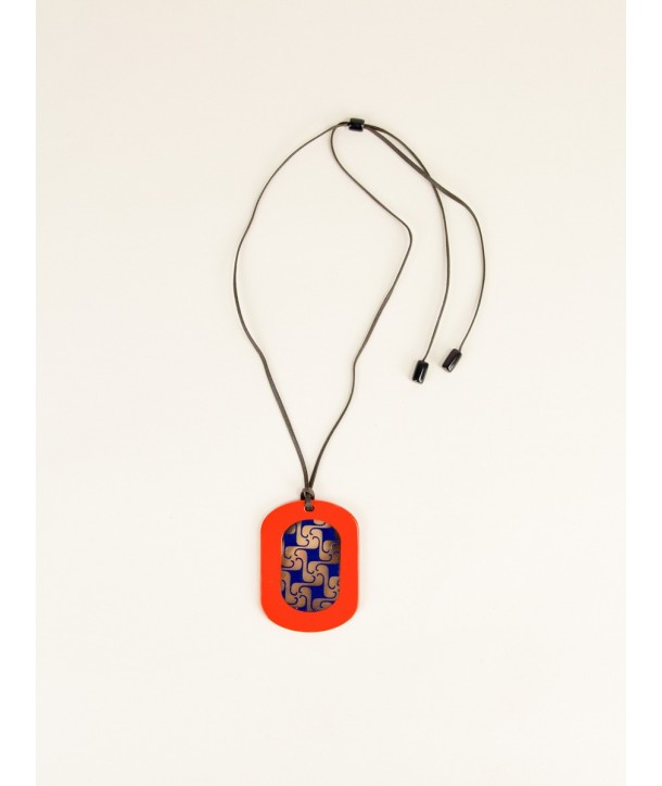 Oval geometric pendant with orange and indigo lacquer