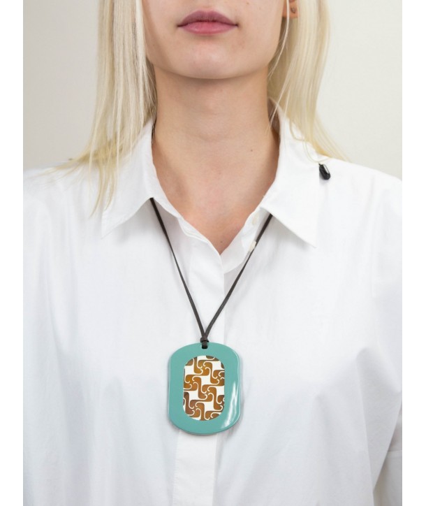 Oval pendant with geometrical motifs with off white and